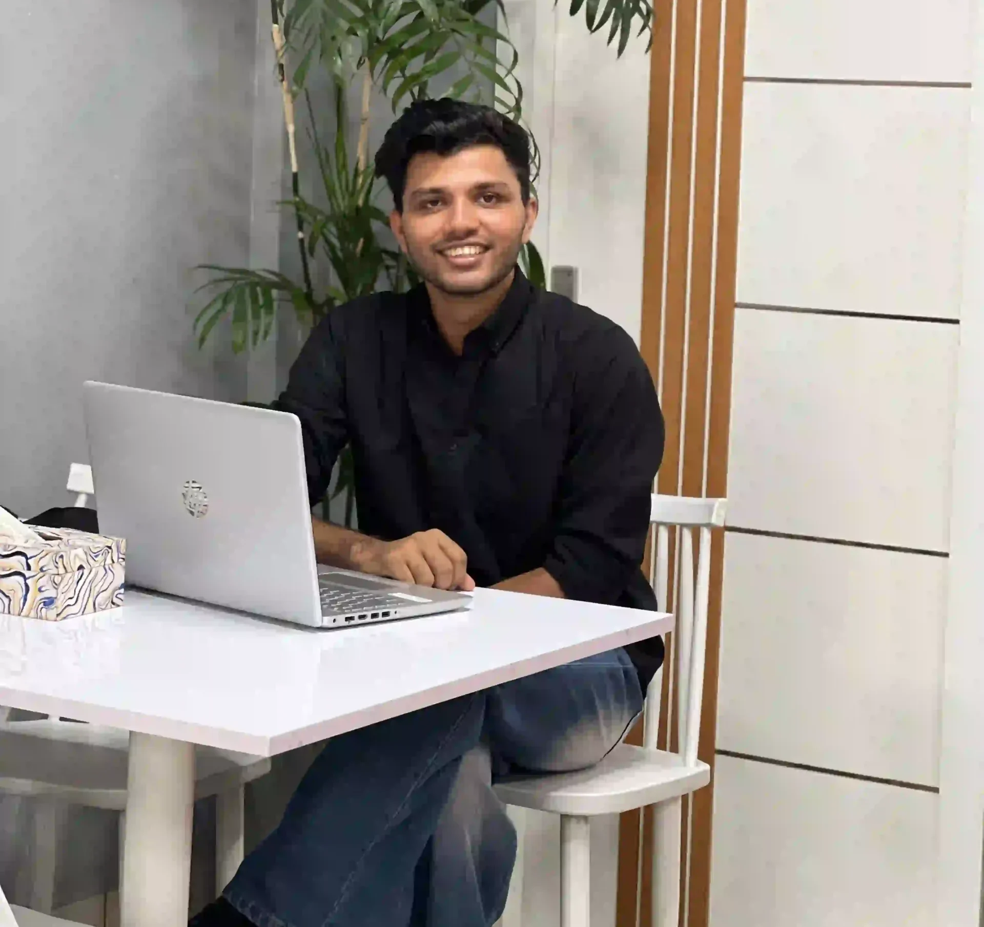 an image of a men sitting in a chair with laptop freelance digital marketing strategist in kannur,kerala