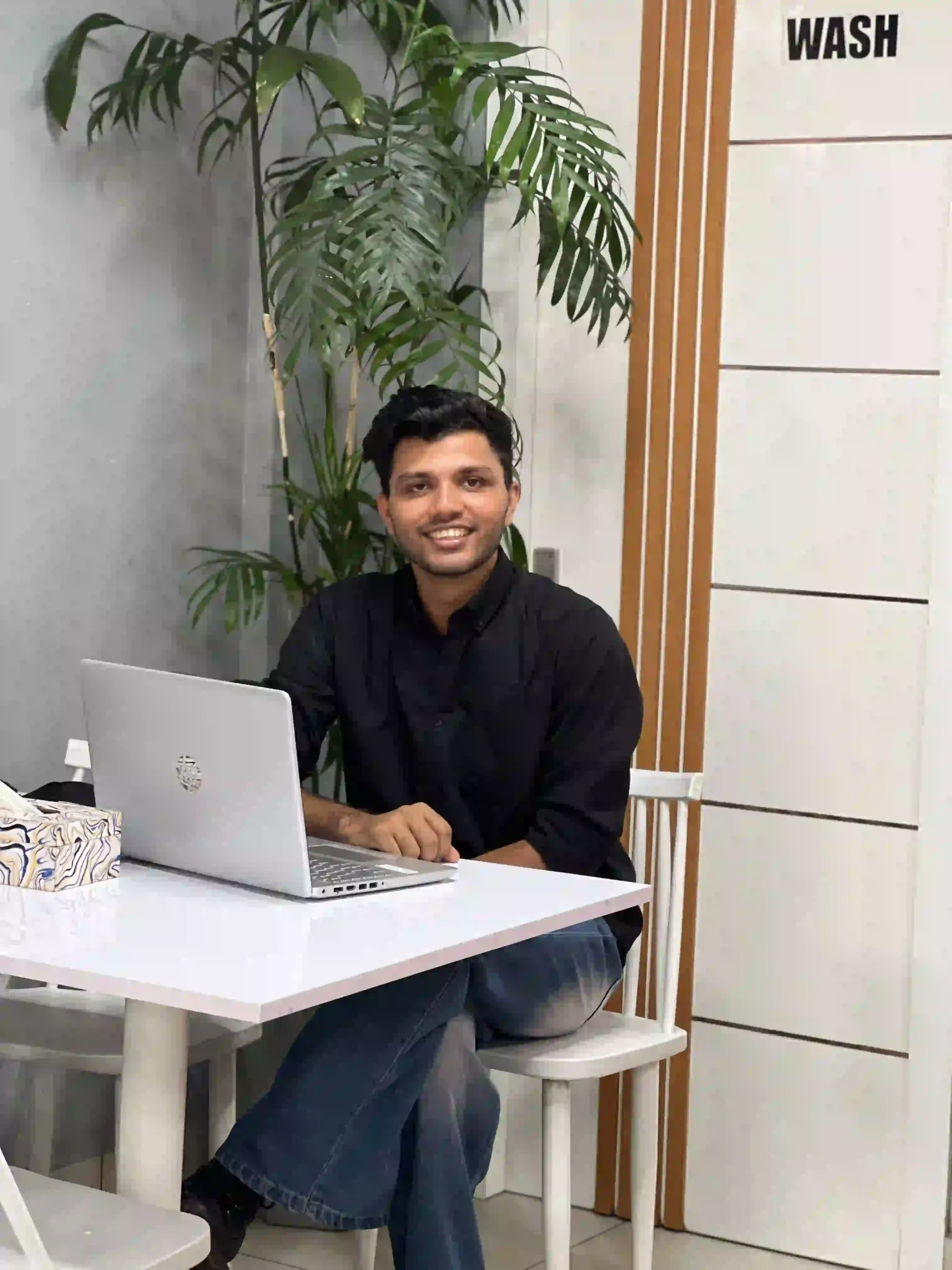 an image of a men sitting in a chair with laptop Top digital marketing strategist in kannur,kerala